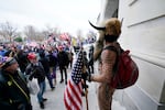 Trump supporters gather outside the Capitol, Wednesday, Jan. 6, 2021, in Washington. As Congress prepares to affirm President-elect Joe Biden's victory, thousands of people have gathered to show their support for President Donald Trump and his claims of election fraud.
