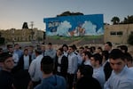 A tour group from a religious seminary visits the site of the former police station in Sderot on March 20. Hamas militants attacked and killed civilians and police officers in Sderot on Oct. 7.
