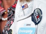 A woman wears a North Carolina delegate button during a campaign event with Vice President Harris on July 11, 2024 in Greensboro, N.C.