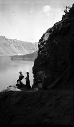 Visitors in the early 1900s view Crater Lake and Wizard Island, formed from an ancient volcano in the Cascade Range. William Gladstone Steel first hiked to its rim 130 years ago and later helped measure its depth using weighted piano wire.
