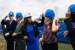 Chelsea Andrews (white hat), president and executive director of Montgomery County's Housing Opportunities Commission, adjusts Maryland State Delegate Lorig Charkoudian's hardhat during a groundbreaking ceremony for the Hillandale Gateway housing development in Silver Spring, Md. The HOC says it owns more than 9,400 apartment, townhome and single-family home rental properties and provides subsidized housing for more than 9,300 households.