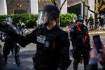 Portland police officers direct protesters back to Chapman Square Park, Portland, Oregon, Saturday, Nov. 17, 2018.