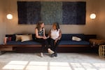 Sudbury (left) and Mireles chat before a fundraiser for Rasa in Washington, D.C. Both women are seated on a long couch.