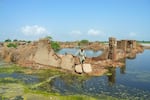 A man walks over his collapsed mud house after heavy monsoon rains in Jaffarabad district, Balochistan province, on Aug. 28.