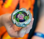 Hobie, 9, shows off the different Beyblades he has and how he uses them in battles at the final Beyblade tournament being held at the Lloyd Center shopping mall in Portland, Ore., on Aug 2, 2026. The tournaments will be moved to Gambit’s Games and BatCave Games after the Lloyd Center closes.