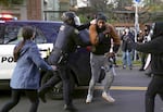 FILE - Police arrest a protester outside the Red House in Portland, Ore., where a group of people attempted to stop an eviction process Dec. 8, 2020.