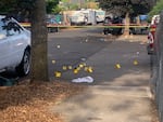 In this OPB file photo, numbers mark areas where law enforcement collected bullet casings and other evidence after an Aug. 10, 2021, shooting that left two people dead and four injured in Northeast Portland near the intersection of Fremont and 82nd Avenue. Although overall crime is not up in Oregon, Portland saw record homicides in 2021.