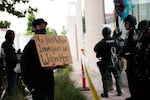 Federal law enforcement officers hold a police line at the Portland ICE building on SW Macadam Avenue Thursday, June 28, 2018, after officials worked to clear the entrance to the building. 