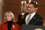 President Barack Obama stands with Lilly Ledbetter before signing the Lilly Ledbetter Fair Pay Act during an event in the East Room of the White House on Jan. 29, 2009.