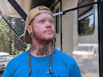 Jordyn Evans, a camp host at Crater Lake, stands in front of his motorhome on Sept. 5, 2024.