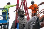 Crews work to remove one of the country's largest remaining monuments to the Confederacy, a towering statue of Confederate General Robert E. Lee on Monument Avenue, Wednesday, Sept. 8, 2021, in Richmond, Va.