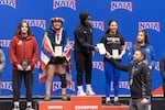 Zaynah McBryde receives her plaque after winning the 2025 championship for her weight class.