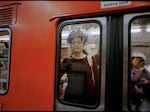 A woman in the window of a women-only metro car in Mexico City on October 2023.