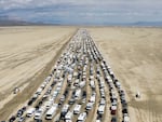 Vehicles seen departing the Burning Man festival in Black Rock City, Nev., on Monday.