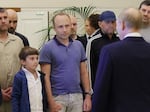 A man identified as Pablo González, second from left with shaved head, listens to Russian President Vladimir Putin, speaking to released Russian prisoners upon their arrival at the Vnukovo government airport outside Moscow, Russia, on Thursday, Aug. 1, 2024.