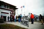 Voters cast their ballot at VFW Post 738 with the state Capitol building in view in Des Moines, Iowa.