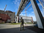 A Russian serviceman guards in an area of the Zaporizhzhia Nuclear Power Station in territory under Russian military control, southeastern Ukraine, on May 1, 2022.