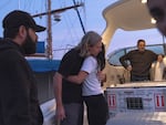 Jason Meier and Maggie Shaarawi, cofounders of Animals Lebanon, embrace before the yacht takes Sara the lion cub out of the country.