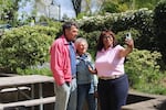 U.S. Rep. Janelle Bynum, D-Oregon, takes a video with Greg and Ellen Wilt, farmers from Sublimity who attended a health care discussion in Silverton.