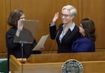 Governor Tina Kotek takes her oath of office, with her wife, Aimee Kotek Wilson, by her side at the Oregon Capitol in Salem, Ore., Jan. 9, 2023.