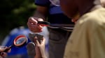 On a hike at Oxbow Regional Park in August 2024, participants in an outing organized by People of Color Outdoors learn about geology on the bank of the Sandy River.