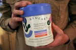 A man holds a container of ByHeart baby formula, which was recently recalled by ByHeart, in Flagstaff, Ariz., on Wednesday, Nov. 12, 2025.