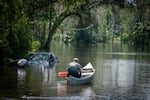 After speaking with members of Hillsborough County Fire Rescue a man paddles back into a flooded neighborhood in Valrico, Florida. Flooding from a nearby waterway turned nearby neighborhoods into rivers forcing dozens to evacuate their homes.