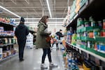 Rachel Negro-Henderson stands in an aisle, looking at shelves of canned food, at the Aldi in Bellmawr, New Jersey, on March 2.
