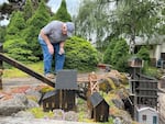 Tom Gaps runs his backyard garden train, the "Lone Pine & Western Railroad," in June 2024.
