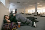 FILE - Rachawna Lee from Gresham rests in the sleeping area of the Cook Plaza cooling center in Gresham, Ore., on Aug. 15, 2023.