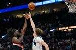 Portland Trail Blazers guard Jrue Holiday (5) shoots as Dallas Mavericks forward Cooper Flagg defends shoot during the second half of an NBA basketball game Friday, March 27, 2026, in Portland, Ore.