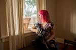 Mia Rose holds her custom built AR-15 in her home in Eugene, Oregon on December 12, 2022.