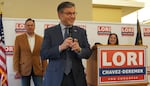 House Speaker Mike Johnson, R-Louisiana, revs up a crowd of about 150 Republicans at a rally for U.S. Rep. Lori Chavez-DeRemer, right. U.S. Rep. Russ Fulcher, R-Idaho, looks on, Oct. 24, 2024.