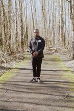 Darrell Wade poses for a photo in a forest of green.