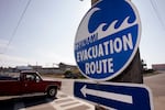 FILE - In this Oct. 3, 2006 photo, a sign directs traffic to an evacuation route in the event of a tsunami on the Quileute Indian reservation in La Push, Wash.