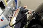 FILE: An attendant pumps gas at a station in Portland, Ore., in 2015. An Oregon law passed nearly seven decades ago banned drivers from pumping their own gas, but now that's changing. 