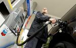 FILE: An attendant pumps gas at a station in Portland, Ore., in 2015. An Oregon law passed nearly seven decades ago banned drivers from pumping their own gas, but now that's changing.