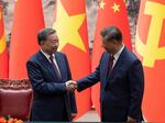 Chinese President Xi Jinping, right, and Vietnam's President To Lam shake hands after a signing ceremony at the Great Hall of the People in Beijing on Monday.