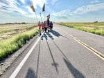 A Catholic parish against abortion rights begins a two-day walk on Interstate 70 west of Watkins, Colo., on Aug. 19, 2022.