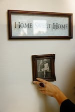 A “Home Sweet Home” decoration along with family portraits of an adoptee’s American family in her home in Southern California on Feb. 21.