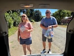 Jennifer and Wes Miller unload a summer meal bag, delivering to eight families while on their countryside route in Falls City, Ore., July 31, 2026.