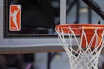 FILE - The WNBA logo is seen near a hoop before an WNBA basketball game at Mohegan Sun Arena, May 14, 2019, in Uncasville, Conn.