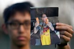 Harrison Li holds a photo of his father, Kai Li, on Jan. 23, 2024, in Palo Alto, California.