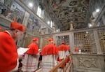 Cardinals file into the Sistine Chapel for a conclave to elect a new pope on March 12, 2013 in the Vatican.