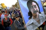 FILE - Marchers carry a large painting of jailed American Indian Leonard Peltier during a march on the National Day of Mourning in Plymouth, Mass., Nov. 22, 2001.