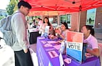 Potential voters get information at a voter registration event on October 22, 2024 at Cal State Los Angeles in Los Angeles, California, ahead of the 2024 US presidential elections on November 5. (Photo by Frederic J. BROWN / AFP) (Photo by FREDERIC J. BROWN/AFP via Getty Images)
