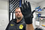 Nelson County, Ky., jailer Justin Hall shows an electric shock glove that is used at his facility, Thursday, Aug. 13, 2026, in Bardstown, Ky.