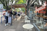 A line of waiting customers wraps around the corner in front of Pipsqueak Bagels in Portland, Ore. on May 10, 2026.
