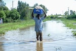 A man walks through floodwaters in Kisumu, Kenya, April 17.