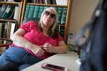 Teresa Christian sits back as she listens to a trained audio describer describe the eclipse as it passes through Nashville, Tennessee.